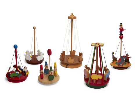 A collection of six carousels, comprising: one by Gill Murkin, painted wood, ribbon, with an elephant, seal and clown perform