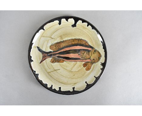 An early 20th Century stoneware iron and ash glazed studio plate, centred with fish design, having label verso, with date 192