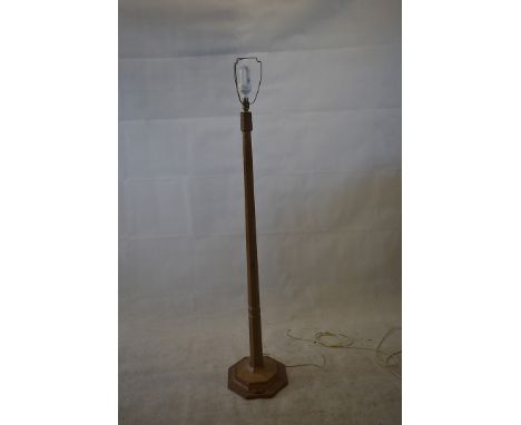 A oak 'Mouseman' standard lamp, of octagonal form, adzed finish, carved with a mouse, 138cm high, base 32cm wide