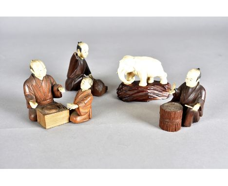 Three Meiji period Japanese box wood and ivory figures, modelled seated at work, together with a Meiji period Japanese ivory 