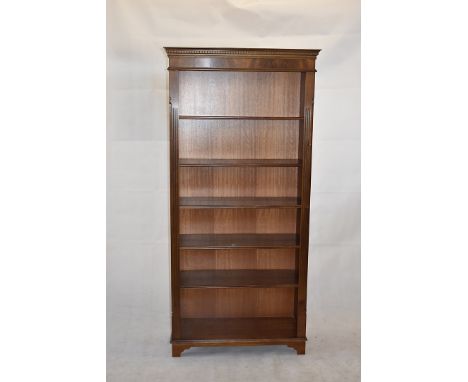 A Georgian-style open mahogany bookcase,  with dentil frieze, above adjustable shelves on bracket supports, 190cm high x 85cm