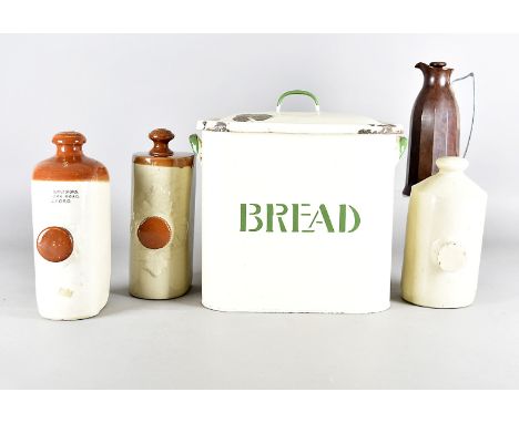 An Art Deco bread bin, with cream ground and green writing, together with a brown Bakelite flask, three stoneware hot water b