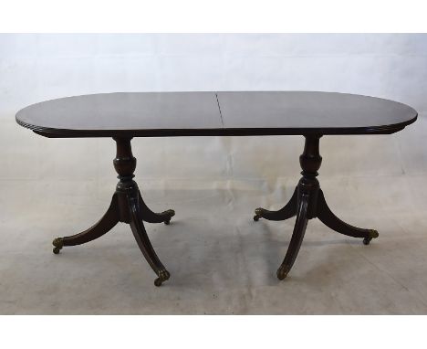 A D end dining table, complete with two leaves, 182cm long without leaves, on tripod bases, with brass claw casters, together