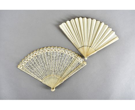 A 19th Century bone brise fan, with pierced decorative design, held with silk ribbon and pink ribbon, 17cm, together with a 1