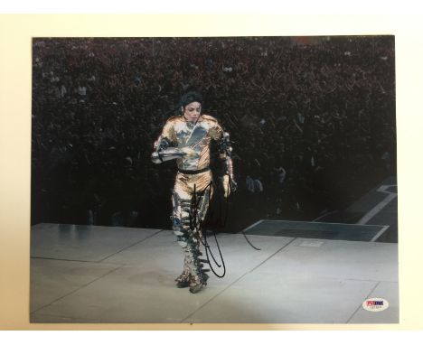 MICHAEL JACKSON SIGNED PHOTOGRAPH - A colour photograph of Michael Jackson on stage during the History tour, signed in black 