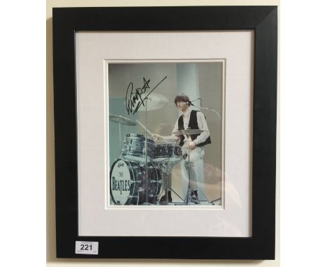 RINGO STARR SIGNED PHOTOGRAPH - A colour photograph of Ringo Starr playing the drums, signed by Ringo in black felt tip pen. 