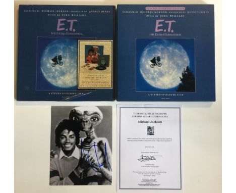 MICHAEL JACKSON SIGNED PHOTOGRAPH - A black and white photograph of Michael Jackson with E.T. signed in blue felt tip pen. Me