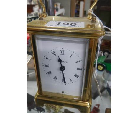 A brass carriage clock.