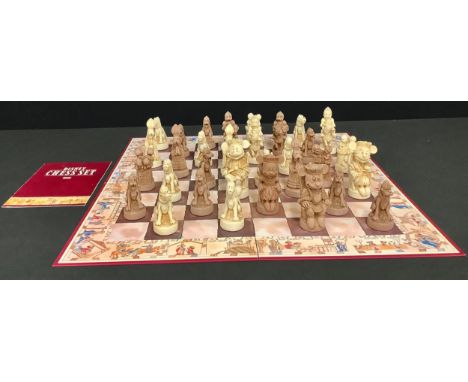 A novelty Disney chess set and folding board, the pieces as Mickey Mouse and companions, unpainted, the border of the chess b