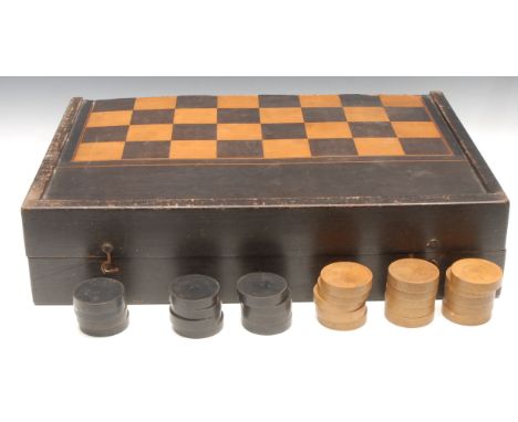 A large 19th century parquetry and ebonised retangular games box, inlaid with a chess board, the interior laid out for backga