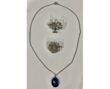 A 935 silver flower basket brooch; an enamel pendant; a filigree brooch 