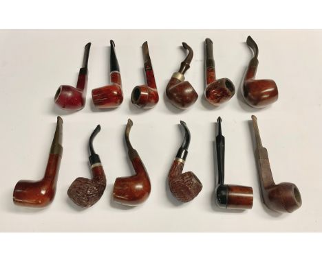 A collection of twelve briar pipes, including, Dr Plumb London, K &amp; P Peterson, Peterson’s Tyrone etc 