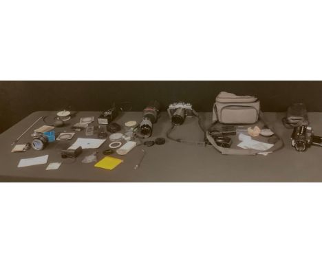 A Minolta XG-M 35mm camera, Hoya Skylight 55mm lens; a Sigma Hoya Skylight 52mm macro lens, cased; an Olympus XA 2 pocket cam