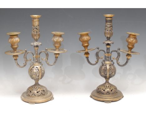A pair of 19th century Renaissance Revival parcel-gilt and silvered bronze three-light candelabra, pierced and cast throughou