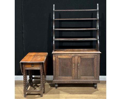 An oak open library bookcase, waterfall superstructure above a pair of panel doors, 184.5cm high, 104cm wide, 39.5cm deep; an