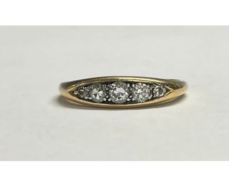 An 18ct gold diamond ring, set with five graduated brilliant cut stones, size O, 4.2g 