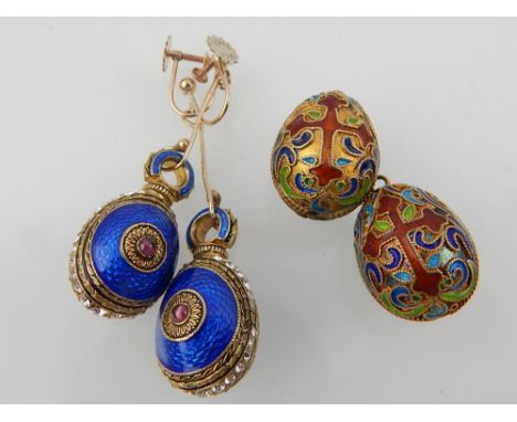 Pair of enamel egg earrings and two multi-coloured enamel decorated egg pendants. (3) 