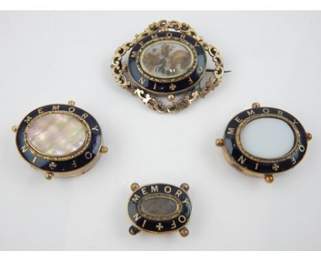''In memory of'', black enamel brooches, opaline and mother-of-pearl centres, the largest 6cm w. 