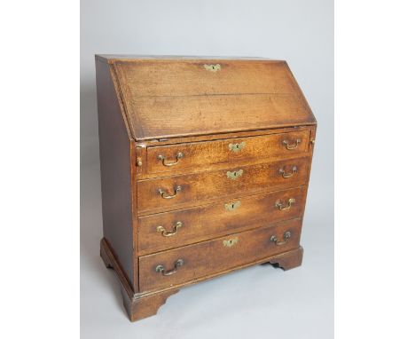 A Georgian oak fall front bureau, the interior fitted with drawers and pigeonholes, over four long graduated drawers raised o