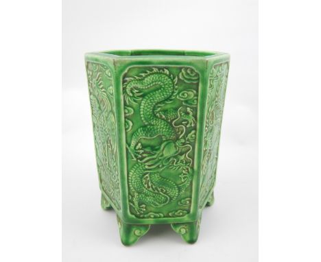 Chinese green ceramic hexagonal brush pot, dragon and bird of paradise decoration, set on six scroll bracket feet, impress st