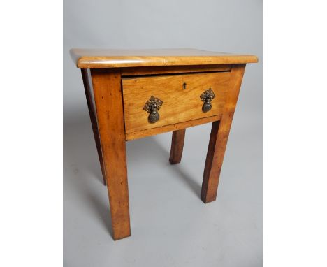 A continental fruitwood lamp table with deep frieze drawer raised on rectangular section legs, 62 x 50 x 35cm. 