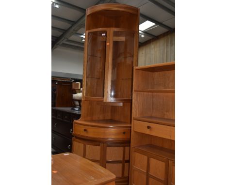 A vintage Nathan corner unit having upper shelf over glazed display section frieze drawer and cupboard to base, height approx