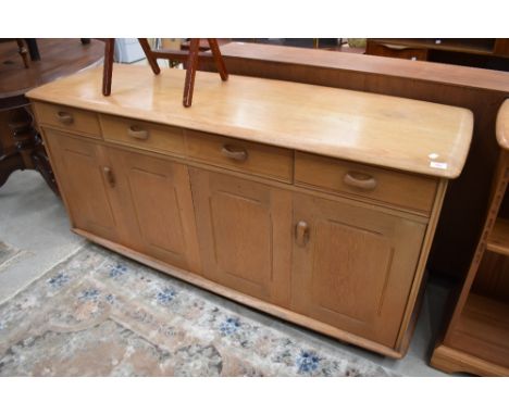 A light stained side board in an Ercol style having bifold doors, dimensions approx. W160cm H75cm