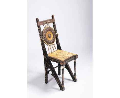 CARLO BUGATTI 1856 - 1940: A CHAIR Ca. 1900 Ebonized walnut, tin inlay, hammered and patinated brass, bone, painted rawhide, 