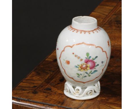 An 18th century Chinese ovoid tea caddy, painted in the famille rose palette with flowers and sprigs, outlined in iron red an