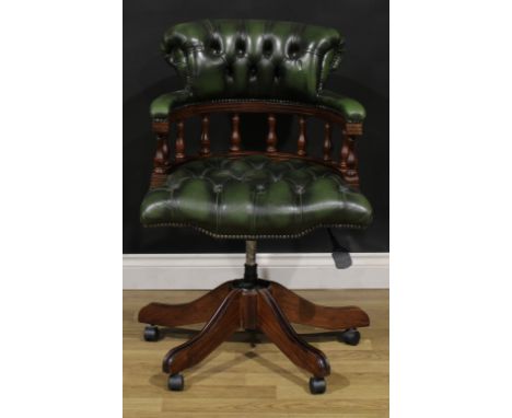 A Chesterfield type swivel office chair, stuffed-over deep button upholstery, 89cm high, 64cm wide, the seat 50cm wide and 41