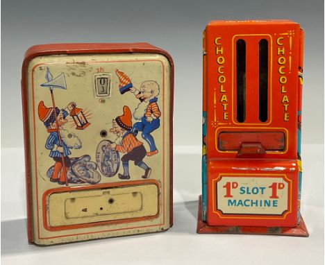 A novelty tinplate moneybox, as a penny slot chocolate machine, 14cm high; another (2) 