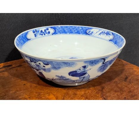 A Chinese circular bowl, playing in tones of underglaze blue with figures in a monumental landscape, 23cm diam, four characte