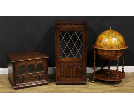 A Da Vinci type bar globe, 92cm high, 59.5cm diameter; an Olde Court oak media cabinet, 103cm high, 53cm wide, 47cm deep; ano