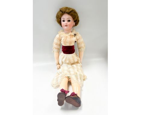 A Simon & Halbig bisque head fashion doll, late 19th or early 20th century, with sleeping brown glass eyes, open mouth reveal