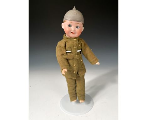 A Max Handwerck bisque headed soldier doll, with grey-blue glass ‘side-glancing’ eyes, open smiling mouth, dimple to chin and