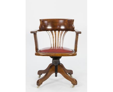 EARLY TWENTIETH CENTURY STAINED BEECH RECLINING OPEN ARM DESK CHAIR, of tub form with pierced splat, padded seat in close stu