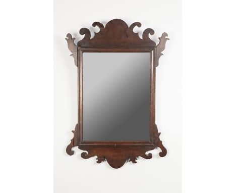 NINETEENTH CENTURY MAHOGANY WALL MIRROR IN THE GEORGE II STYLE, the oblong plate in a moulded frame with fret cut scrolled cr