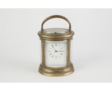 A LATE 19TH CENTURY REPEAT CARRIAGE CLOCK in scroll engraved brass oval case with four curved bevelled plate glass panels  an