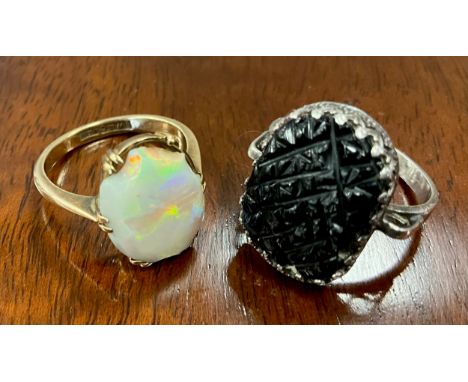 An opal cabochon ring, flashing strong green, violet and red play, 9ct gold shank, size M, 3g gross;  a Whitby jet lattice pa