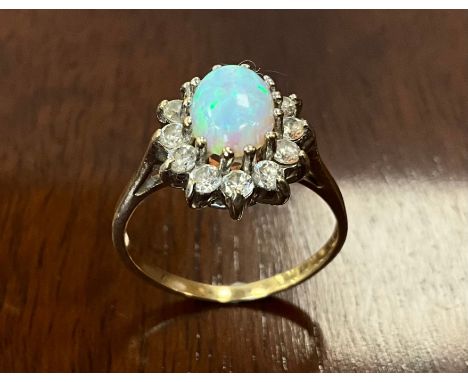 An opal and Cubic zirconia oval dress ring, 9ct old shank, size M, 2.4g gross