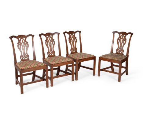 A set of four George III mahogany side chairs, circa 1780, in the manner of Thomas Chippendale, each shaped foliate C-scroll 