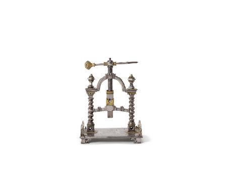 A rare South German steel and brass mounted table top book press, 17th or early 18th century, the arched frame mounted with f