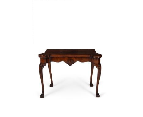 A George II Irish mahogany card table, circa 1750, the hinged rectangular top with rounded outset corners, opening to baize i