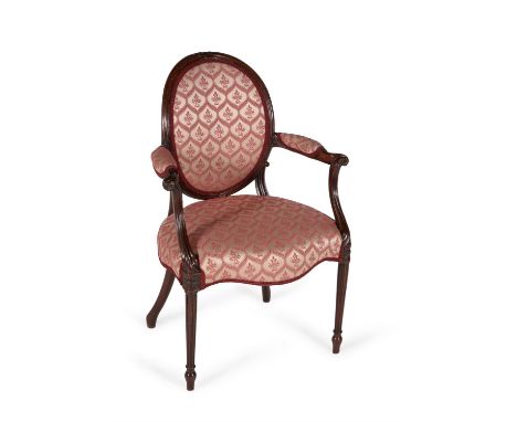 A George III mahogany and upholstered open armchair, circa 1780, in the manner of George Hepplewhite, the padded and upholste