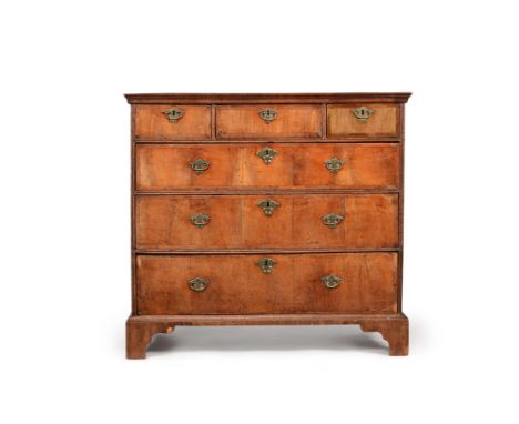 A George I walnut and crossbanded chest of drawers, circa 1725, the rectangular top with moulded edge, above three short and 