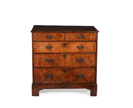 A George II walnut and crossbanded chest of drawers, circa 1740, the rectangular top with moulded edge, above two short and t