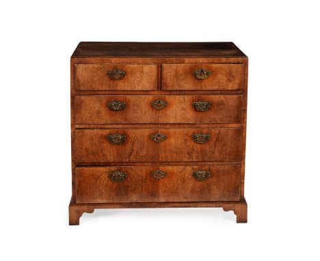 A George II walnut, crossbanded and pine chest of drawers, circa 1730, the rectangular caddy top and moulded edge, above two 