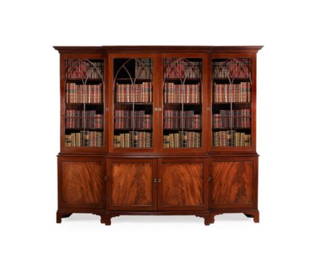 A George III mahogany breakfront library bookcase, circa 1790, the dentil moulded cornice above a pair of lancet astragal gla