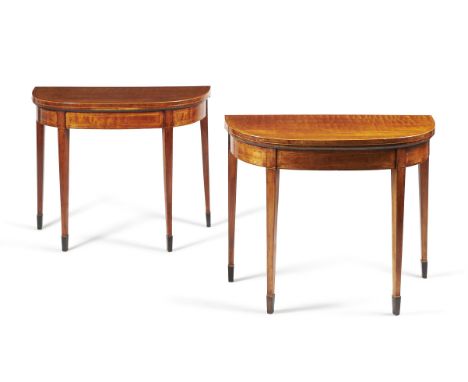 A pair of George III figured mahogany and crossbanded card tables, circa 1790, in the manner of Thomas Sheraton, each hinged 