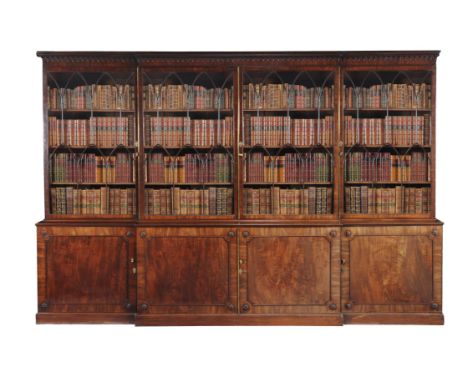 A George III mahogany breakfront library bookcase, circa 1780, the dentil and pendant moulded cornice above four astragal gla